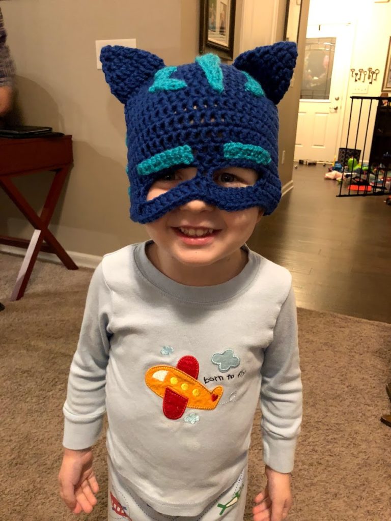 Toddler boy wearing a PJ Masks Catboy mask after Fontan heart surgery.