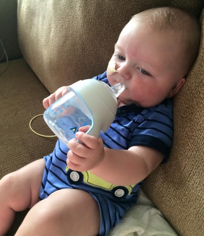 Baby with CHD cooling off with some water during hot weather. 