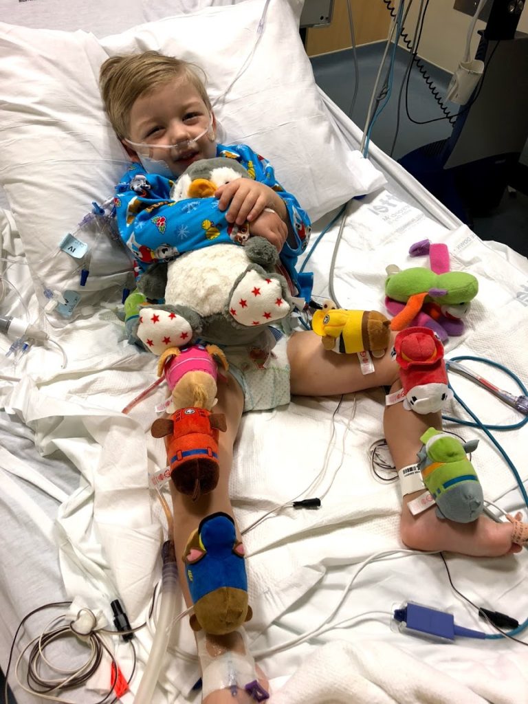 Toddler playing with his toys in the hospital.